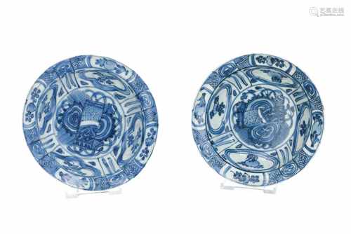 A pair of blue and white 'kraak' porcelain 'klapmuts' bowls, decorated with swastika and flowers