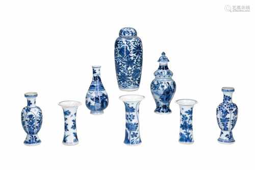 Lot of eight blue and white porcelain miniature vases, decorated with figures and flowers. One