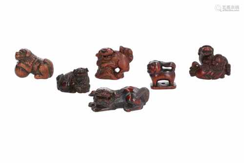 Lot of six netsuke, 1) Wooden shishi on rock. Signed Gechu. H. 4 cm. 2) Wooden shishi with ball.