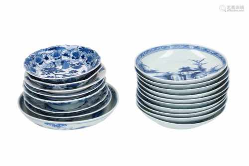 A set of ten blue and white porcelain saucers, decorated with buildings in a river landscape.