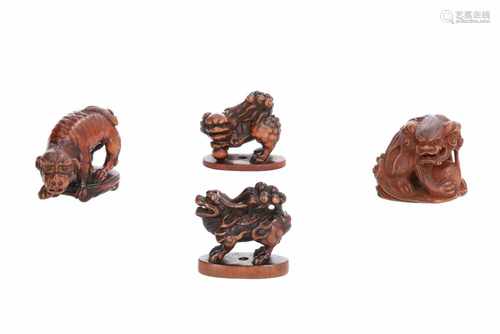 Lot of four netsuke, 1) Wooden shishi on base. H. 3,5 cm. 2) Wooden shishi with ball. Signed