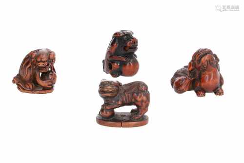 Lot of four netsuke, 1) Wooden sitting shishi with ball on base. Signed Masatoshi. H. 3,5 cm. 2)