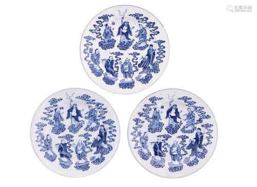 A lot of three blue and white porcelain dishes, decorated with the eight immortals standing on