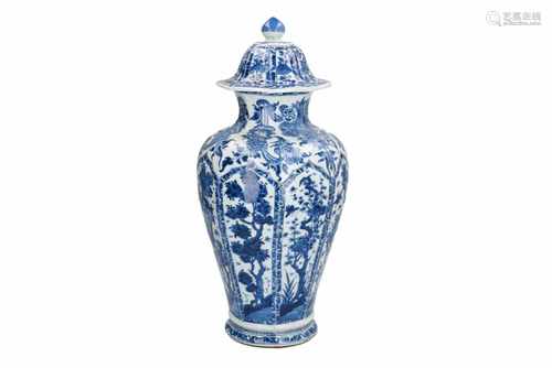 A large octagonal blue and white porcelain lidded baluster vase, decorated with flowers, grapes,