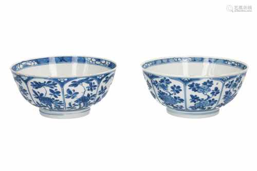 A 'near-pair' of blue and white porcelain bowls with floral decor. One marked with 6-character