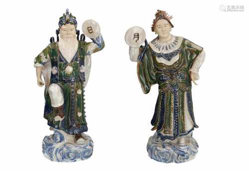 A pair of polychrome earthenware sculptures, depicting two dancing figures. Marked with seal mark.