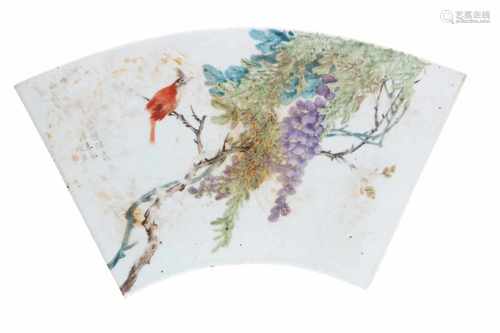 A polychrome porcelain fan shaped plaque, decorated with a bird in a tree. China, 20th century. L.