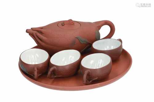 A Yixing tea service, including a teapot in the shape of Buddha's hand, four cups and a tray.