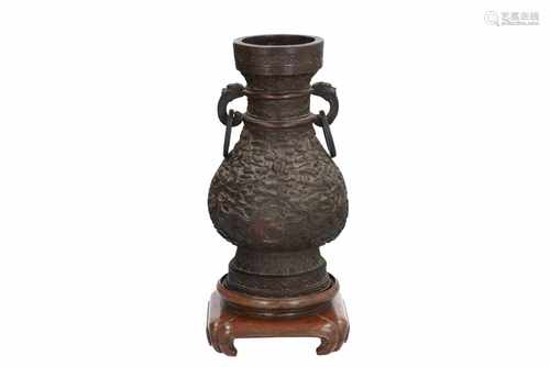 A bronze altar vase on wooden base, with relief decor of dragons chasing the burning pearl in the