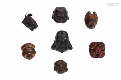 Lot of seven netsuke, 1) Wooden shishi mask with moving jaw and ears. H. 3 cm. 2) Wooden, nine