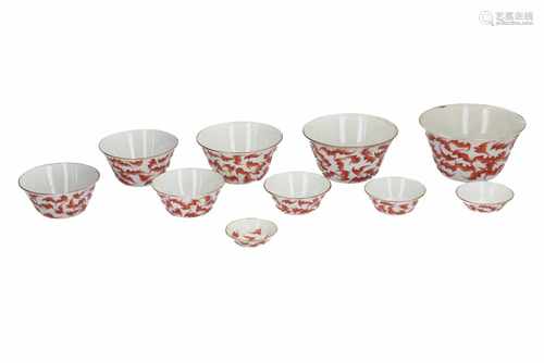 A polychrome porcelain set of ten bowls which fit in each other, decorated with bats. Marked with