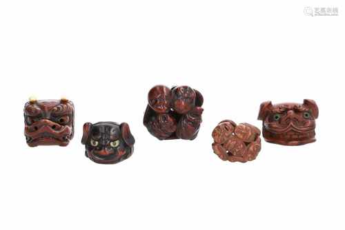 Lot of five netsuke, 1) Wood with lacquer, shishi head with copper eyes. H. 3 cm. 2) Wooden shishi