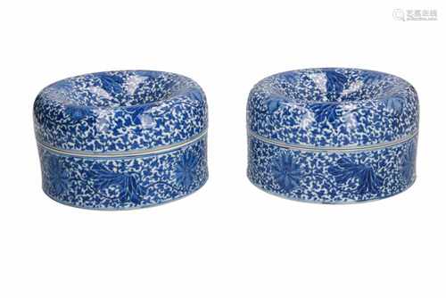 A pair of blue and white porcelain spittoons with loose upper rim, decorated with flowers. Marked