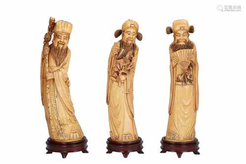 Lot of three ivory sculptures on wooden bases, depicting dignitaries. All signed. China, ca. 1900.