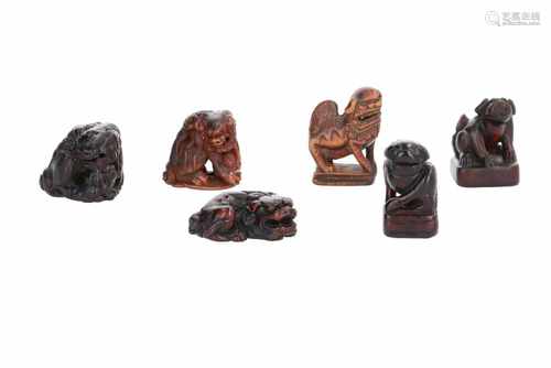 Lot of six netsuke, 1) Wooden shishi on base. H. 4,5 cm. 2) Wooden shishi on base with seal. H. 4