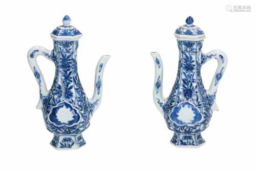 A pair of blue and white porcelain wine ewers with floral decor, partly in relief. Unmarked.