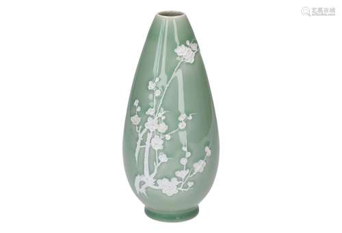 A celadon porcelain vase, decorated in relief with flowers, highlighted with white. China, Yixing,