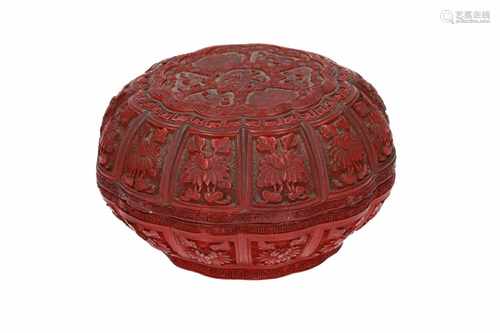 A round red lacquer lidded cinnabar box, with carved decor of flowers. Unmarked. China, 19th