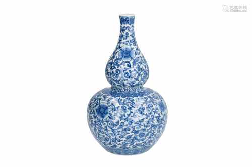 A blue and white porcelain vase with floral decor. Marked with seal mark. China, 19th century. H.