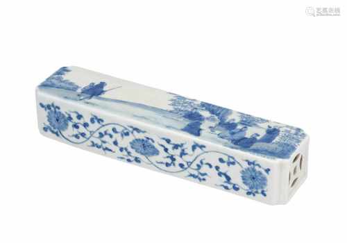 A rectangular blue and white porcelain scroll weight, decorated with scholars and flowers. Unmarked.