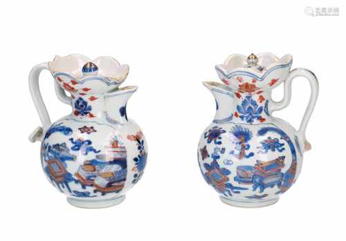 Lot of two Imari porcelain lidded high collar jugs, decorated with flowers and antiquities. Handle