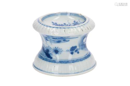 A blue and white porcelain salt cellar, decorated with flowers and figures in a garden. Unmarked.