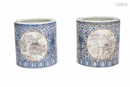 A pair of polychrome porcelain brush pots, decorated with flowers and mountainous landscapes in