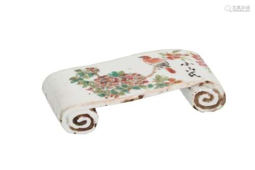 A polychrome porcelain scroll shaped brush rest, decorated with birds on a branch. Dated 1961.