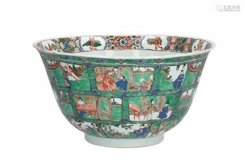 A large Famille Verte porcelain bowl, decorated to the exterior with panels in three bands depicting