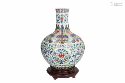 A Doucai porcelain vase on wooden base, decorated with flowers and geometric pattern. Marked with