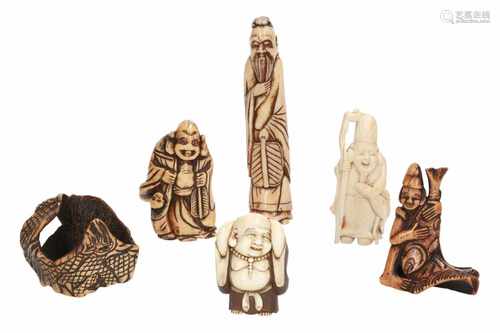 Lot of five netsuke, 1) Ivory shishi with cub. H. 4 cm. 2) Ivory shishi with flower ball. H. 4,5 cm.