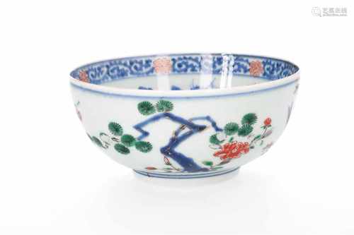 A polychrome porcelain bowl with partly overglaze painted floral decor. Marked with artemisia