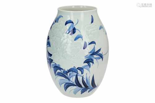 A blue and white porcelain vase, with relief decor of flowers. Dated 2001. Signed Wanglin (1972),