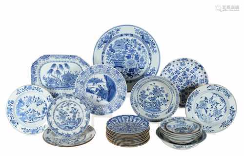 A lot of 27 blue and white porcelain objects, including chargers and dishes, mostly with floral