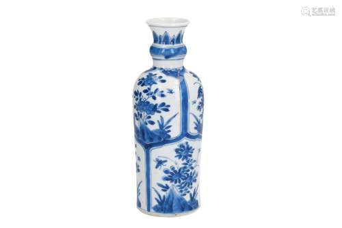 A cylindrical-shaped blue and white porcelain vase, decorated with flowers on rocks in reserves.