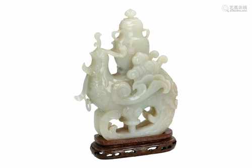 A jade sculpture on wooden base, depicting a chicken with vase on its back. China, 20th century.