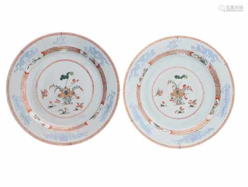 A pair of polychrome export porcelain chargers, decorated with flowers and birds and underglaze