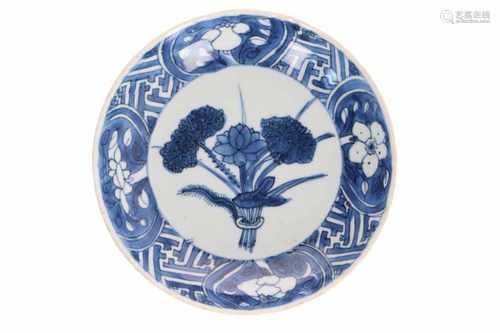 A blue and white porcelain deep saucer, decorated with a rare decor of flowers. Unmarked. China,