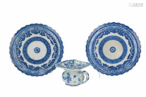 A pair of blue and white porcelain dishes with scalloped rim and floral decor. Added a blue and