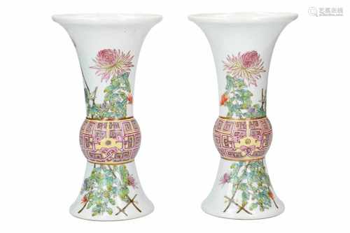 A pair of polychrome porcelain vases, decorated with flowers and a birds. Marked with seal mark Hong