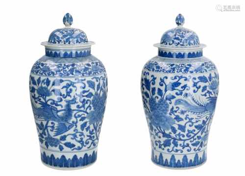 A pair of blue and white porcelain lidded vases, decorated with phoenix and flowers. Unmarked.