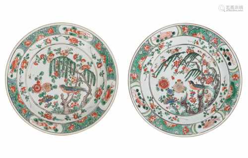 A pair of Famille Verte porcelain dishes, decorated with a singing bird amidst flowers. The rim with