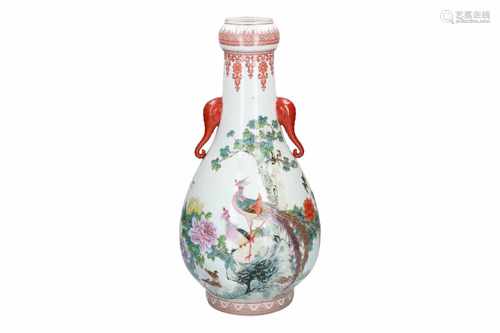 A polychrome porcelain vase with two handles in the shape of elephant heads, decorated with birds,