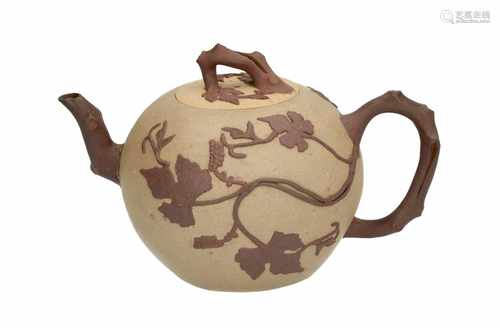 A Duan Ni Yixing teapot with relief decor of grape vines. The handle, grip and spout in the shape of