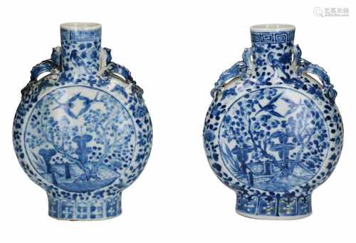 A pair of blue and white porcelain pilgrim bottles, decorated with flowers, birds and trees on a