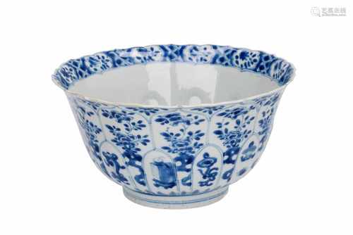 A blue and white porcelain lobbed bowl with scalloped rim, decorated with utensils, antiquities