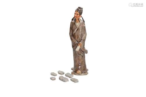 A polychrome porcelain sculpture of a man. Created 1990. Signed Zhang Yu Xian (1938), member of