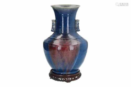 A blue glazed porcelain vase with flaring rim, on wooden base. Unmarked. China, 19th century. H.