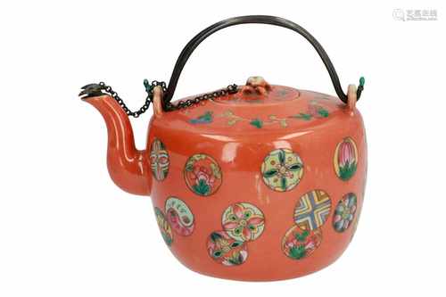 A coral red porcelain teapot, decorated with flowers and circles in which flowers on orange fond.