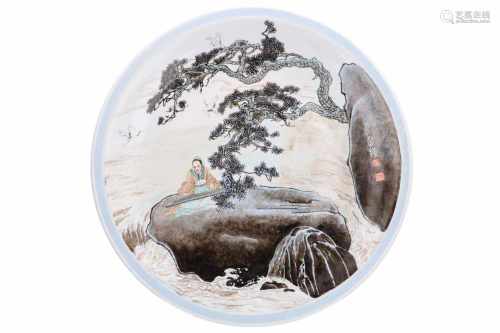 A large polychrome porcelain charger, decorated with figure on a rock in the water. Dated 1990.